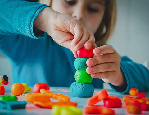 Child building with modelling clay