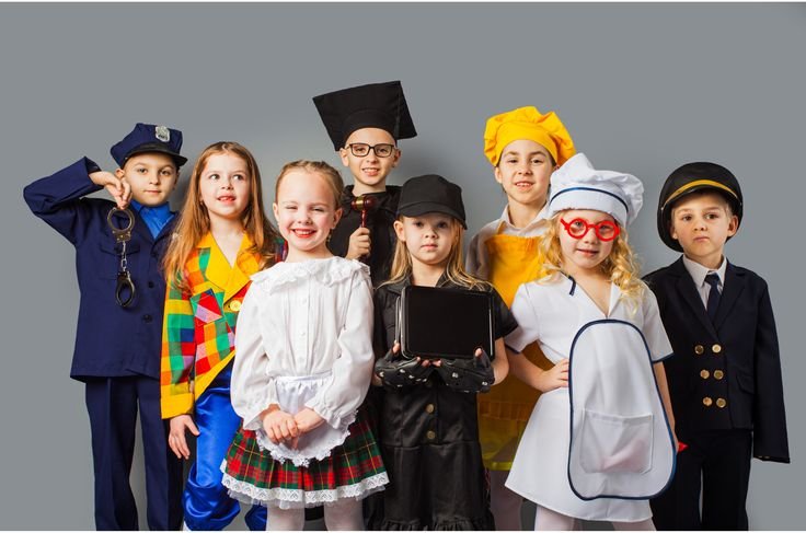 Children in school costumes posing for a group photo